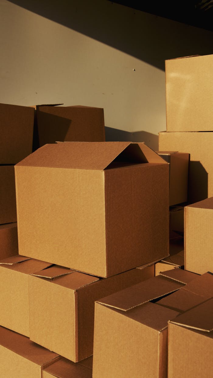 portfolio-02 Stacked cardboard boxes ready for shipping or storage in a warehouse setting.