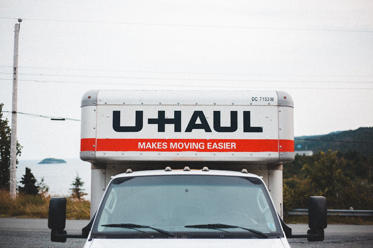 why-choose-us U-Haul moving truck parked on roadside with scenic outdoor backdrop.
